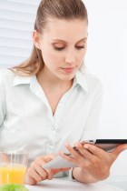 Participant engages with SimplyWell's health management application via a tablet computer.